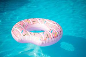 a pink inflatable donut floating in a pool at Gyeongju Gamseong The Glamping Pool Villa in Gyeongju
