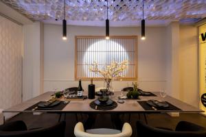 a dining room with a table and chairs at JAPAVISTA Wabi in Osaka
