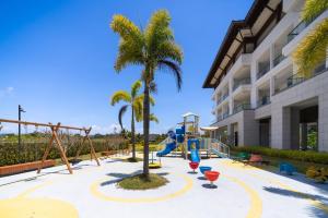 a playground at a hotel with palm trees at CGGC by BOBOLI at Haitang Bay Sanya City#only 50 meters to Beach and Sea Swimming Area in Sanya
