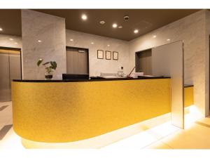 a lobby with a yellow counter in a room at Nihonbashi LUXE HOTEL - Vacation STAY 77602v in Osaka