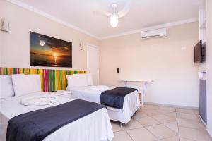 Cama ou camas em um quarto em Pousada Azul da Cor do Mar