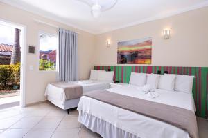 Cama ou camas em um quarto em Pousada Azul da Cor do Mar
