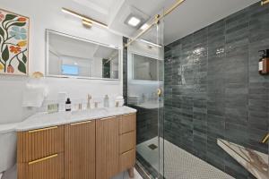 a bathroom with a shower and a sink and a glass shower stall at Ocean View Loft in Little Italy near Downtown-Gaslamp in San Diego +58 photos