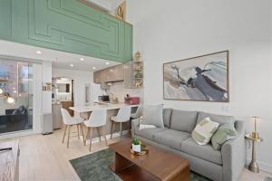 a living room with a couch and a kitchen at Ocean View Loft in Little Italy near Downtown-Gaslamp in San Diego