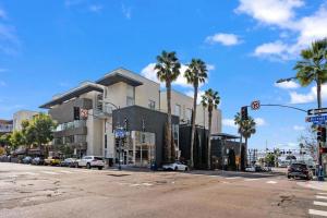 an intersection of a street with palm trees and a building at Ocean View Loft in Little Italy near Downtown-Gaslamp in San Diego
