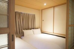 Postel nebo postele na pokoji v ubytování Softlight Inn Asakusa Tokyo