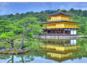 a large yellow building on top of a lake at Marutamachi Crystal Hotel - Vacation STAY 05336v in Kyoto +12 photos