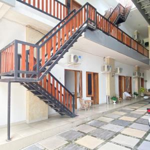 a staircase in a house with a tiled floor at Village Homestay Yogyakarta RedPartner in Yogyakarta