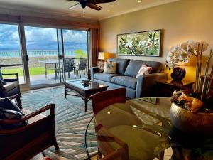 a living room with a couch and a table at A9 Direct Oceanfront 2 Level 2 Lanai Amazing Views Sunsets & AC Comfort in Lahaina