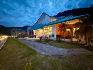 a house with lights on the side of it at Sunset Villa Shirahama 5 min to the beach Pets OK in Shimoda