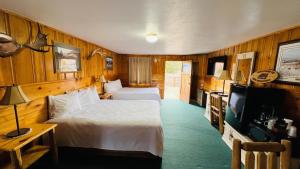 a hotel room with two beds and a television at Trails end motel in Dubois