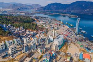 an aerial view of a city next to a body of water at Nami Island Koi Pension in Gapyeong