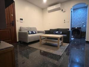 a living room with a couch and a coffee table at Leanitai luxury 1-BR Apartment-203 at Qatif شقة فاخرة بغرفة نوم واحدة in Tārūt