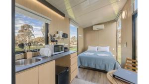 a small bedroom with a bed and a sink at Avon River Homestead by Tiny Away in Beverley