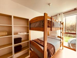 a bedroom with bunk beds and a window at Sweet Home Oxapampa in Oxapampa +4 photos