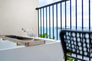 a bathroom sink with a view of a balcony at Yeosu Bokja Pension in Yeosu