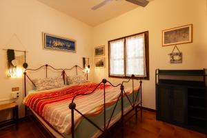 a bedroom with a bed and a piano at Villa Acquario in Torre delle Stelle +53 photos