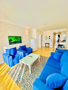 a living room with blue couches and a white table at Luxury View Hotel in Batumi +83 photos