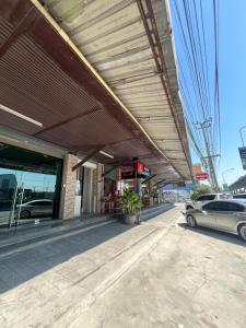 a car parked on a street next to a building at TKH The Bed in Ban Khlong Bang Krathiam +4 photos