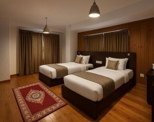 Postel nebo postele na pokoji v ubytování Norbu Healing Hotel