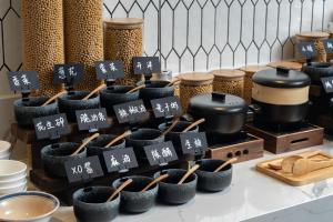 a display of pots and utensils on a counter at Atour Hotel Shanghai Xianxia in Shanghai