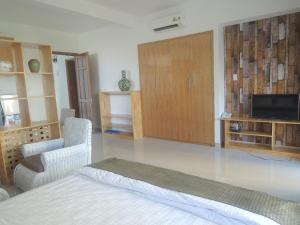 a bedroom with a bed and a tv and a couch at Sky Garden Apartment in Vung Tau