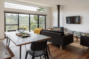 a living room with a table and chairs and a fireplace at Lake View Derby in Derby