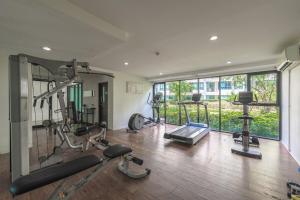 a gym with cardio equipment and a large window at C185 Centrio 2BR Condo Walk to Mall Near Town in Ban Rangeng