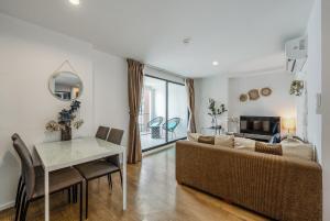 a living room with a couch and a table at C185 Centrio 2BR Condo Walk to Mall Near Town in Ban Rangeng