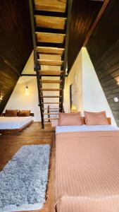 a room with two beds and a staircase at The wilds Sinharaja in Deniyaya