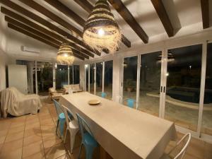 a dining room with a white table and chairs at Terreta de Denia in Denia