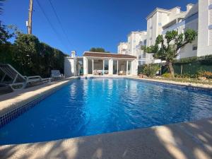 a swimming pool in front of a building at Terreta de Denia in Denia