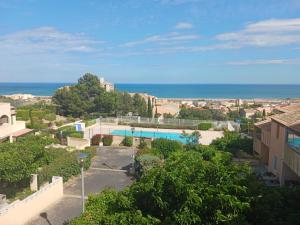 a view of the ocean from a building at Le Sun Piscine Tennis parking Vue mer wi-fi climatisation in Fleury