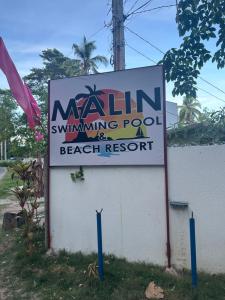 a sign for a swimming pool at a beach resort at Barkada Room 2nd floor, no bfast in Lazi