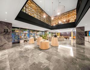 a lobby with a row of tables with plants on them at Atour S Hotel Chengdu Taikoo Li in Chengdu