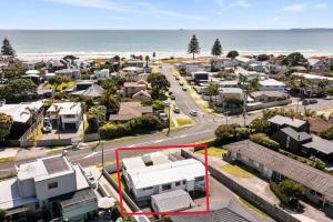 an aerial view of a suburb with the ocean at Peaceful Oasis near the Beach and Mount Mainstreet Shopping Centre in Mount Maunganui