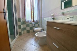 a bathroom with a toilet and a sink at Civico 21 in Càbras +23 photos