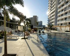 a swimming pool in the middle of a city with buildings at Hotel Porto Horizonte Suite 1426 in Santa Marta