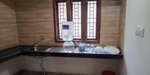 a bathroom counter with a sink and a window at Cloud9Villa Resorts in Yelagiri