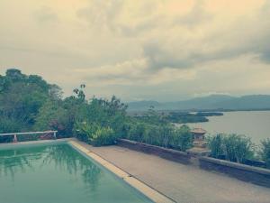 a swimming pool with a view of a body of water at kalaki beach hotel in Daru +26 photos