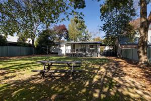 a picnic table in the yard of a house at Toorak Place in Bright