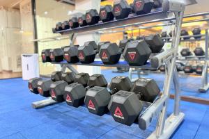 a rack of dumbbells in a gym at Days Inn by Wyndham Patong Beach in Patong Beach