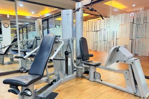 a gym with cardio equipment in a building at Days Inn by Wyndham Patong Beach in Patong Beach
