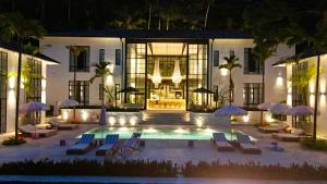 a pool in front of a building at night at Miss Ceylon in Unawatuna