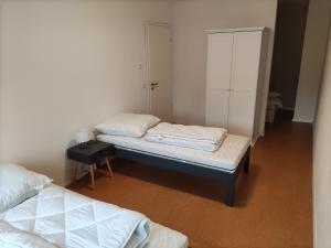 a room with two beds and a cabinet at B4 Spitzenkamp1 in Oldendorf