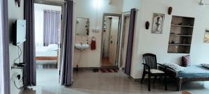 a room with a bathroom with a sink and a mirror at The Home Chikamagalur in Chikmagalūr