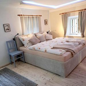 a bedroom with a large bed with a window at Ferienwohnung Urmannsau in Gaming