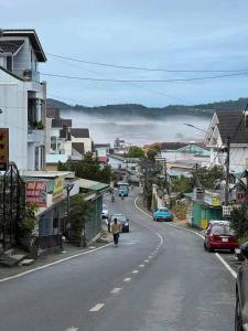a person walking down a street in a town at Amy Hotel & Apartment in Da Thanh +11 photos