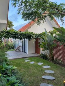 a house with a garden in front of it at NAIA The Villa - Modern Tropical Retreat in Canggu
