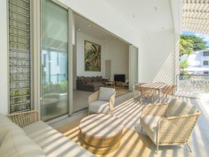 a living room with a couch and chairs on a balcony at Casa Alegria with LOV in Grand Baie